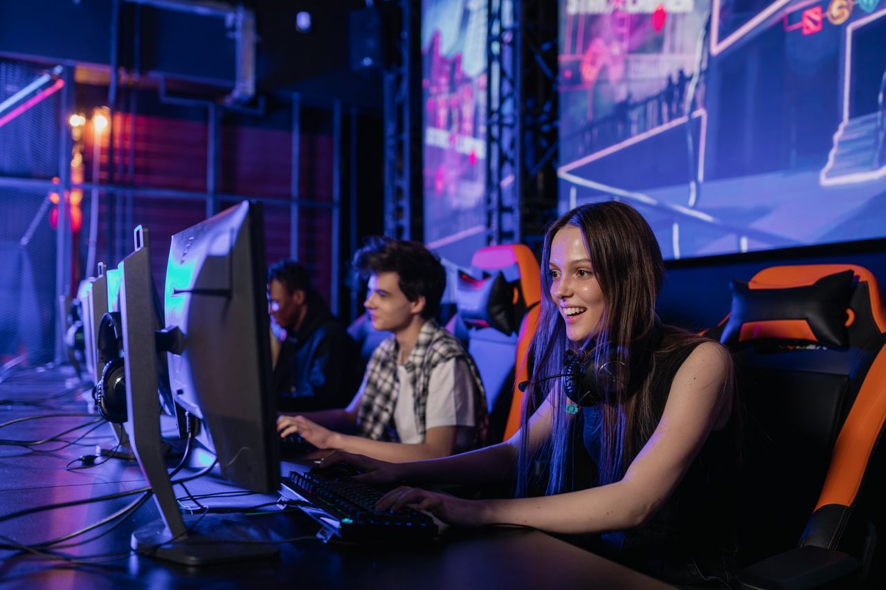 Services A group of young adults enjoying a gaming session in a vibrant esports arena.