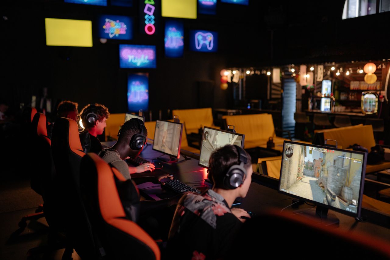Services Group of gamers participating in an online tournament at a modern internet cafe.