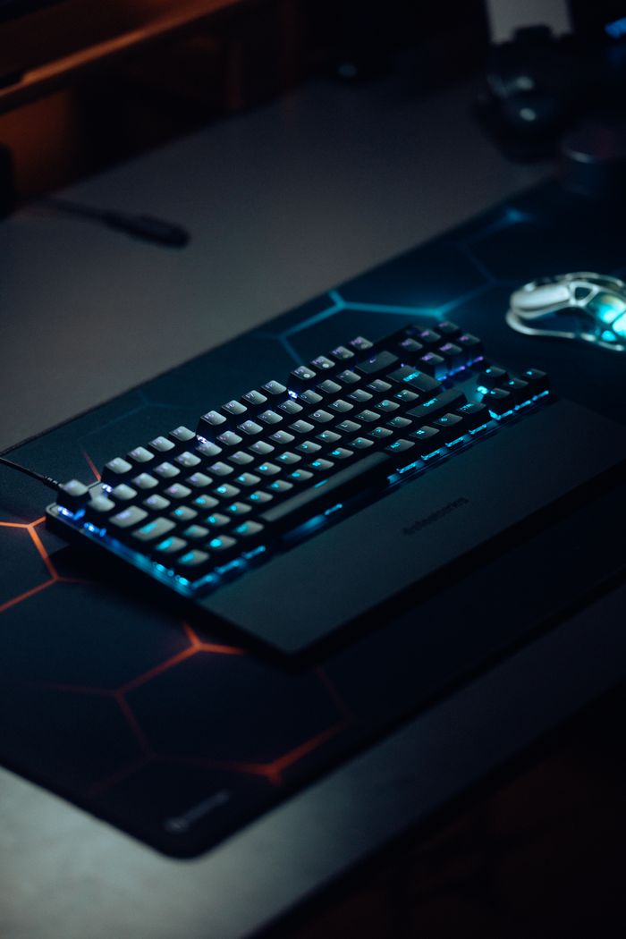 Mastering the First Impression: Your intriguing post title goes here Mechanical keyboard with RGB lighting on a dark gaming setup, perfect for tech enthusiasts.